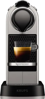 A Nespresso coffee machine with a cup of espresso.