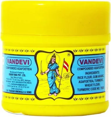 A yellow container of compounded asafoetida with a label featuring an illustration.