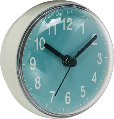 A close-up, slightly angled view of a small, round clock with a teal face and white numbers.
