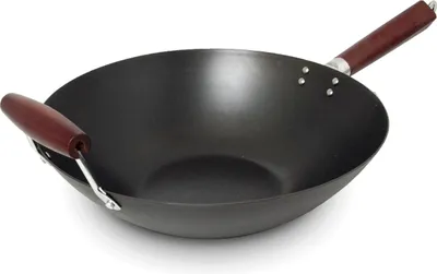 A black carbon steel wok with two wooden handles is shown against a white background.