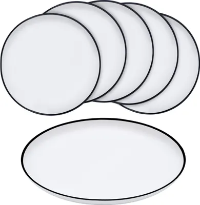 A set of white plates with black rims, stacked and one plate in the foreground.