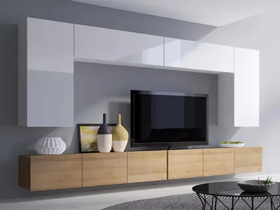 A modern living room wall unit with a TV and decorative items.