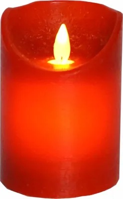 A close-up of a red LED candle with a flickering yellow flame.