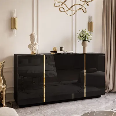 A modern, luxurious living room with a black high-gloss dresser adorned with gold accents. The dresser is styled with decorative items, including a bust, a vase of flowers, and books, suggesting a sophisticated interior design.