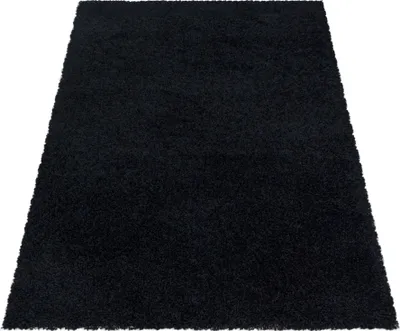 A black rug is shown from a slightly elevated angle against a white background.