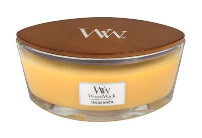 A WoodWick candle with a wooden lid and a label.