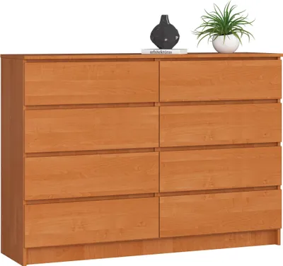 A wooden dresser with eight drawers is shown against a white background. Decorative items, a vase and a plant, are placed on top of the dresser.