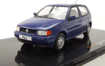 A blue Volkswagen Polo 3 model car is displayed on a black reflective surface against a white background.