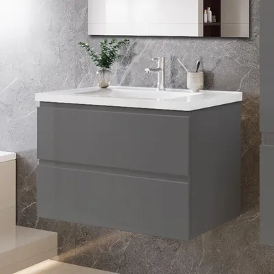A modern bathroom vanity with a sink and two drawers, set against a marble-patterned wall.