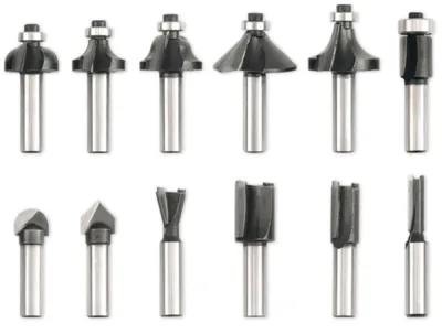 A collection of router bits arranged in two rows against a white background.
