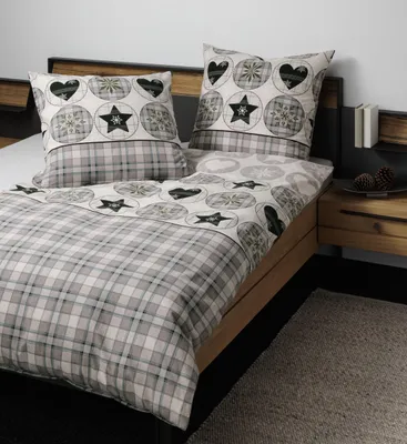 A bed with bedding and pillows.