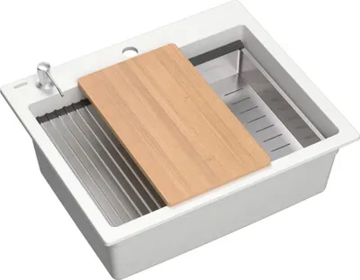A white kitchen sink with a wooden cutting board and a metal dish rack.
