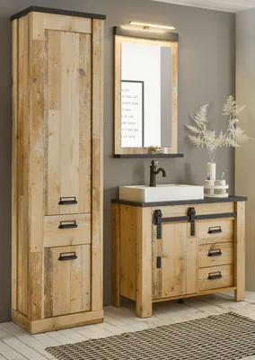 A bathroom vanity and tall cabinet set in a rustic wood finish.