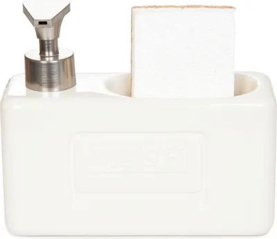 A white ceramic soap dispenser with a silver pump and a white sponge in a holder.