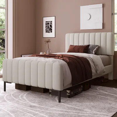 A bedroom scene with a bed, bedding, and wall art.