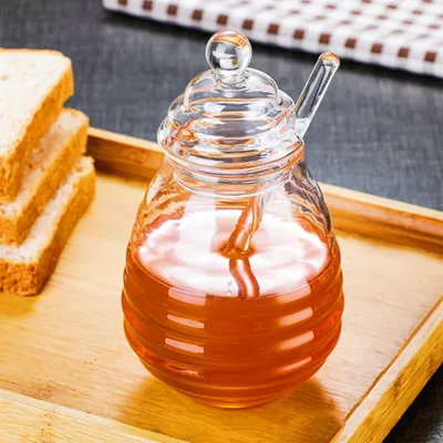 Zdjęcie produktu dla Słoik na miód w kształcie ula, z łyżeczką i pokrywką