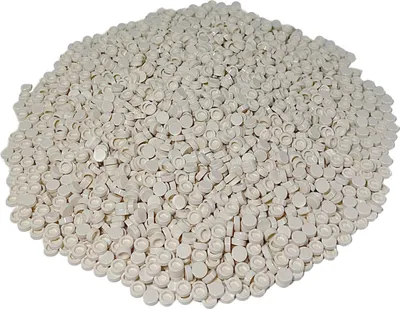 A pile of small, round, white LEGO tiles.