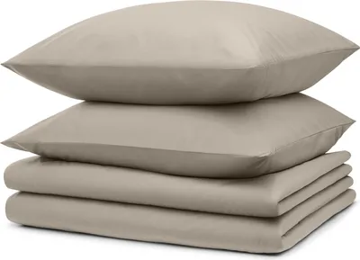 A stack of folded bedding and two pillows.