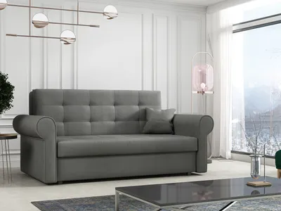 A gray sofa is shown in a well-lit living room with a large window overlooking a snowy landscape.