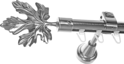 A close-up view of a curtain rod with a decorative leaf finial.