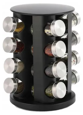 A rotating spice rack with 16 glass jars filled with various spices.