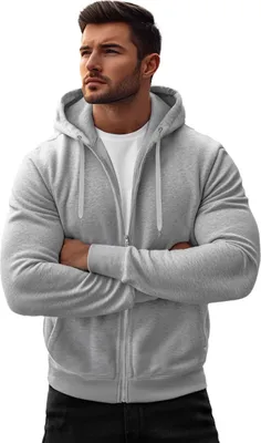 A man wearing a grey zip-up hoodie and a white t-shirt, with his arms crossed.