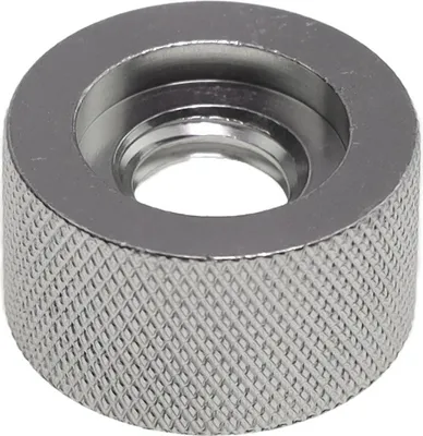 A close-up, studio shot of a metal nut with knurled edges.