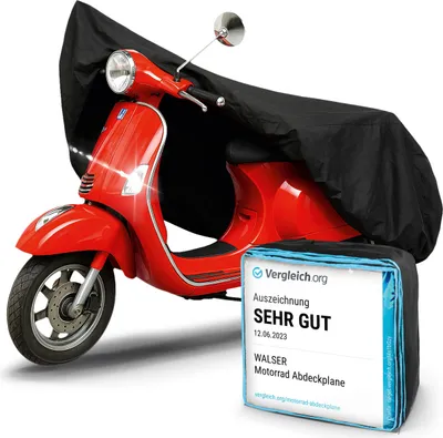 A red scooter partially covered by a black protective cover, with a certification card in the foreground.