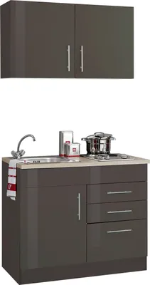A compact kitchen unit with upper cabinets, a sink, and a stovetop.
