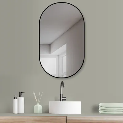 A modern bathroom vanity with a sink, faucet, mirror, and accessories.