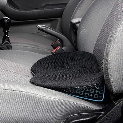 A black seat cushion placed on a car seat.