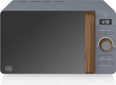 A studio shot of a grey microwave with a wood-effect handle and control panel.