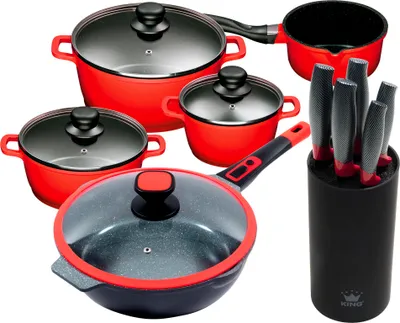 A set of red cookware and a knife block with knives, arranged on a white background.