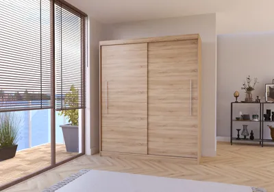 A modern bedroom with a large wooden sliding door wardrobe.