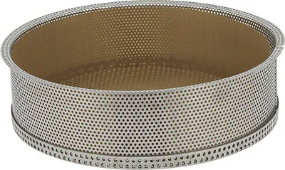 A round, perforated metal baking ring with a brown interior.