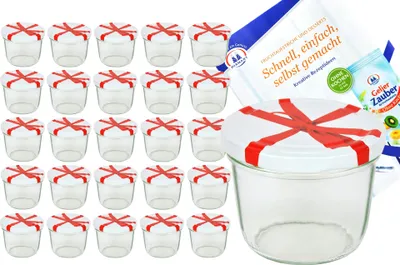 A set of glass jars with lids decorated with red ribbon, along with a recipe booklet.