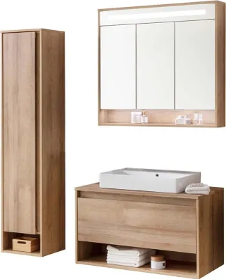 A bathroom vanity set with a tall cabinet, a sink vanity, and a medicine cabinet.