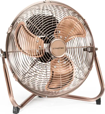 A close-up studio shot of a floor fan with a copper design.