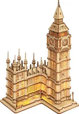A 3D wooden model of Big Ben with lights illuminated.