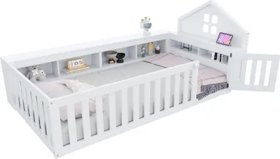 A white wooden children's bed with a house-shaped headboard and storage compartments.