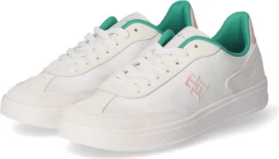 A pair of white Tommy Hilfiger low-top sneakers with green accents.