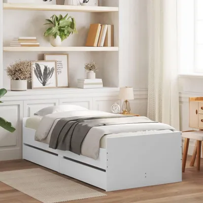 A white bed frame with drawers in a bedroom setting.