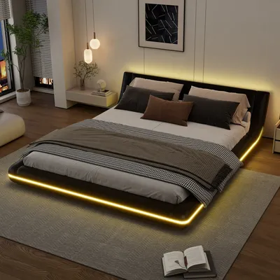 A modern bedroom with a bed featuring LED lighting.