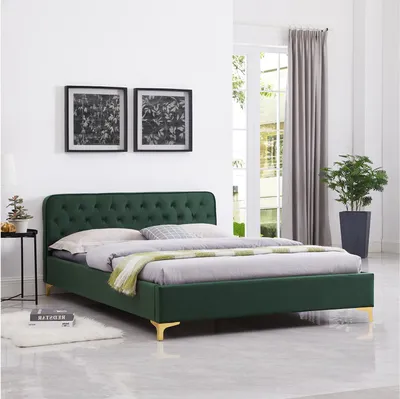 A bedroom scene featuring a green velvet bed.