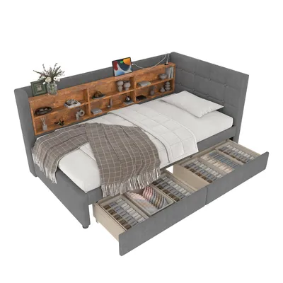 A grey upholstered daybed with a wooden shelf headboard and storage drawers underneath.