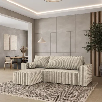 A modern living room with a sectional sofa, dining area in the background, and decorative elements.