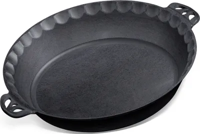 A dark gray cast iron pie pan with decorative scalloped edges and handles, shown from a slightly elevated angle against a white background.