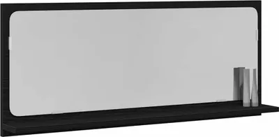 A black shelf with a mirror above it, and two decorative objects on the shelf.
