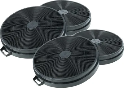 A group of four round, black charcoal filters for a range hood.