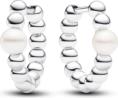 A pair of silver hoop earrings with pearls on a white background.